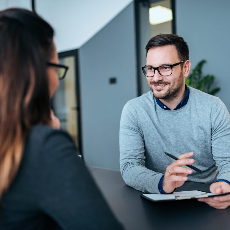 Female person having a job interview with a male recruiter.
