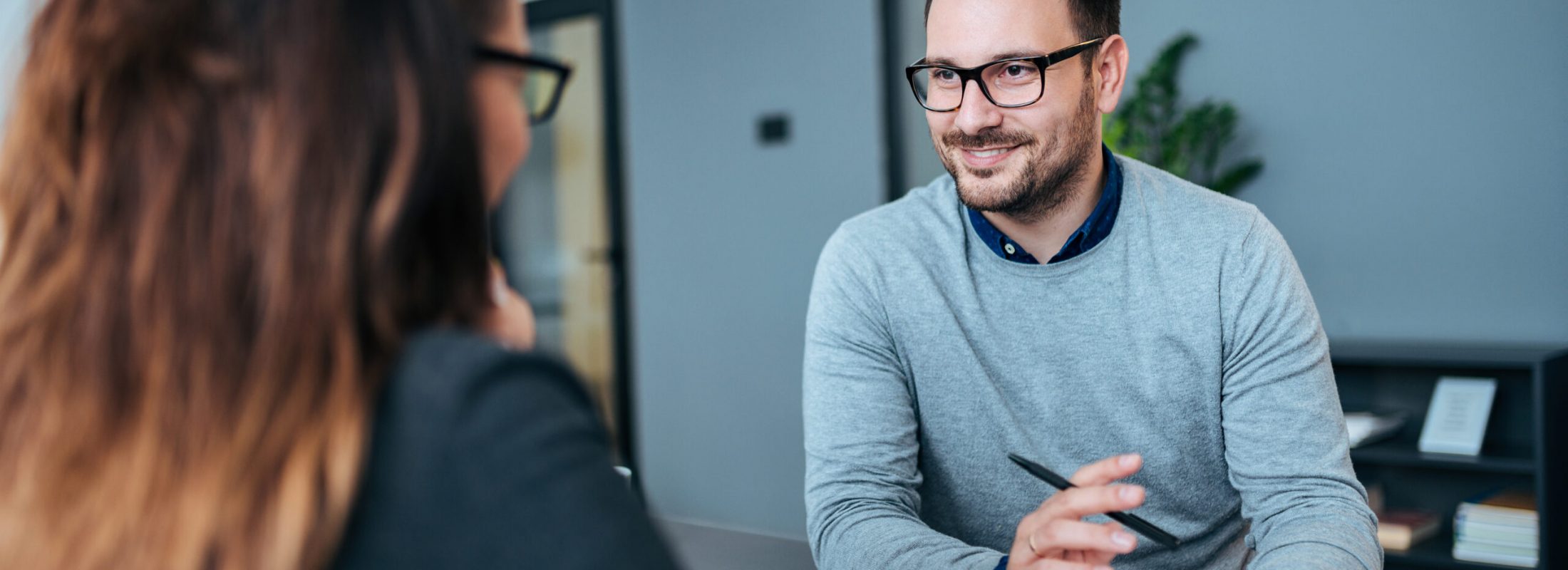 Female person having a job interview with a male recruiter.