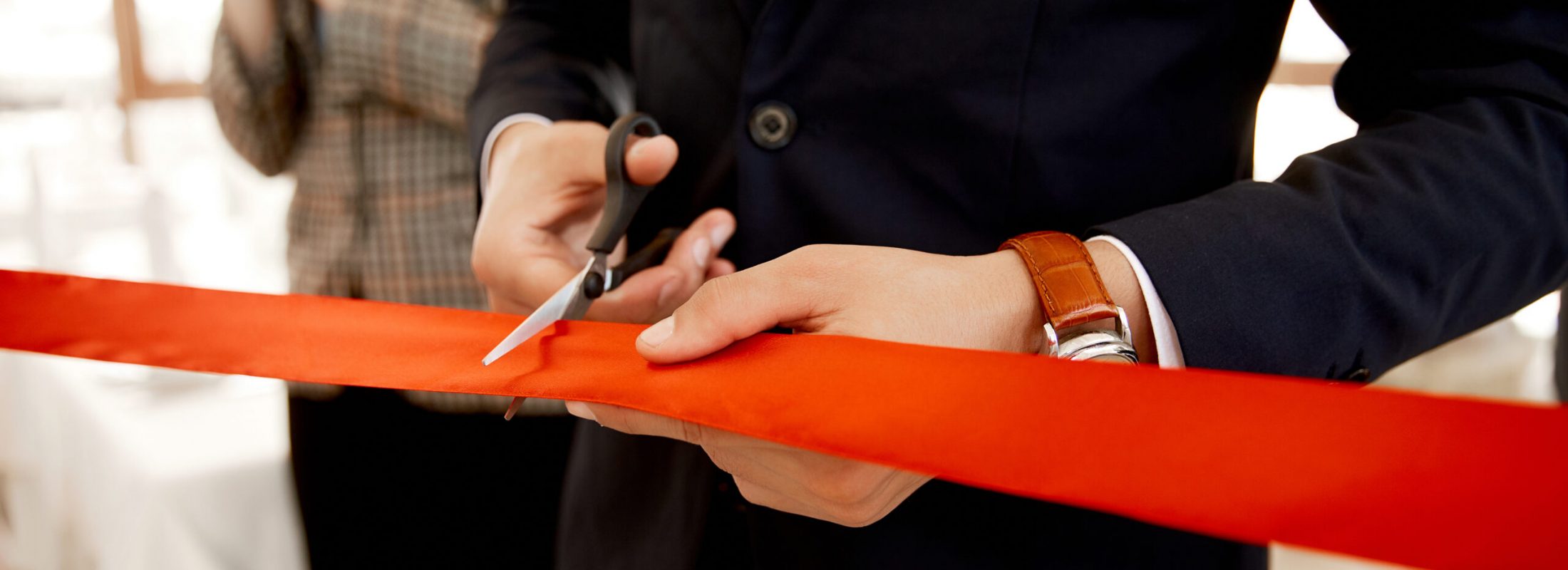 Front view of the cutting the red ribbon on the grand opening of the building